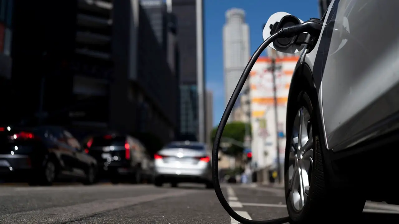 An electric vehicle is plugged into a charger in Los Angeles, on Aug. 25, 2022. (AP Photo/Jae C. Hong, File)